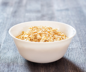 Canvas Print - Bowl of oatmeal on wooden table