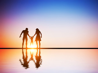 Happy family together, parents and their child at sunset,