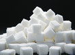 © Mint Images - Pile of sugar cubes, black backdrop