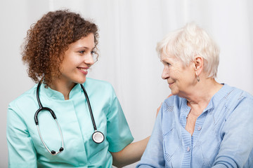 Wall Mural - Smiling nurse and happy elderly lady