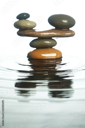 Fototapeta na wymiar Carefully balanced stones in water