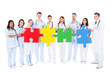 Medical team holding colorful puzzle pieces