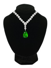 Diamond and emerald necklace on black mannequin isolated on whit