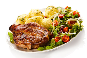 Grilled steak, boiled potatoes and vegetable salad