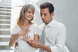 © lightwavemedia - Woman showing engagement ring to man