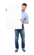© pikselstock - Young man holding blank placard
