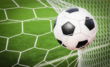 Fototapeta Młodzieżowe - soccer ball in the goal net