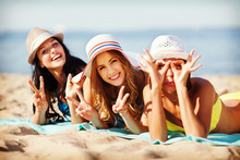 Girls Sunbathing On The Beach