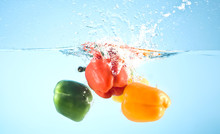 Red And Yellow Pepper Splashed Into Water
