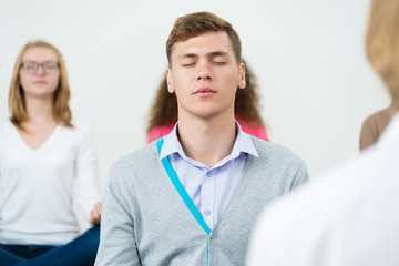 Wall Mural - young man, meditating with closed eyes