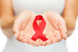 © Syda Productions - hands holding red AIDS awareness ribbon