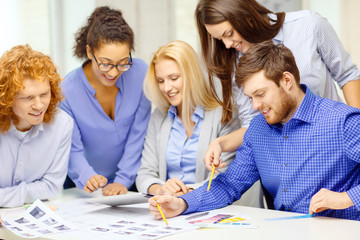 Sticker - smiling team with color samples at office