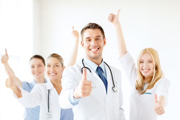 Canvas Print - smiling male doctor in front of medical group