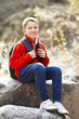 Happy smiling hiker boy with backpack in forest. Dressed in red