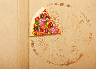 Wall Mural - Salami pizza slice over box.