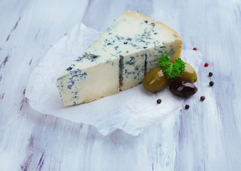 Tasty blue cheese on old wooden table