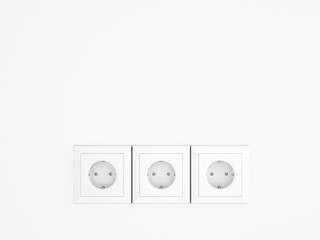 White wall with three european electric outlets.Conceptual.