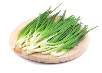 Wall Mural - Bunch of green onion on wooden platter.