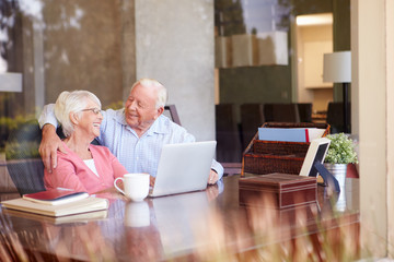 Canvas Print - Senior Couple Using Laptop On Desk At Home