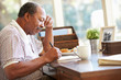© Monkey Business - Senior Man Writing Memoirs In Book Sitting At Desk