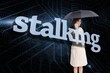 © WavebreakmediaMicro - Businesswoman holding umbrella behind the word stalking