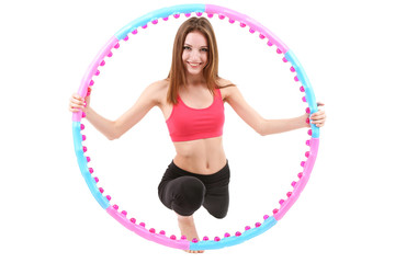 Wall Mural - Woman doing exercises with hula hoop isolated on white