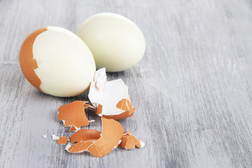 Wall Mural - Peeled boiled egg on wooden background