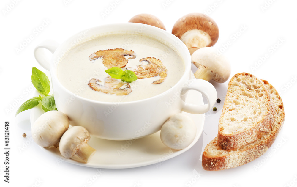 Mushroom soup in white bowl, on plate, isolated on white
