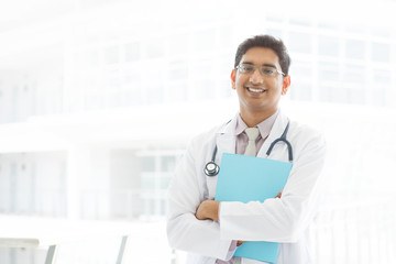 Wall Mural - Asian Indian male medical doctor holding file folder