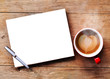 Hot coffee with blank paper note on wood background