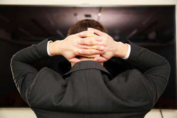 Sticker - businessman standing with arms behind head