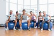 © WavebreakMediaMicro - Fitness class with dumbbells sitting on exercise balls in gym