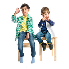 kids doing the ok sign over white background