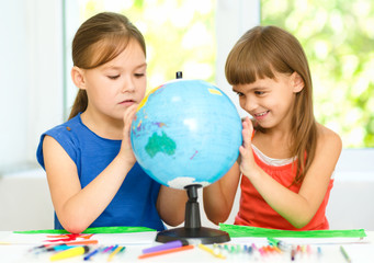 Wall Mural - Little girls are examining globe