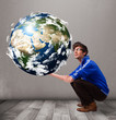 Good-looking man holding 3d planet earth