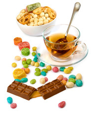 Wall Mural - isolated image of a cup of tea and candy closeup