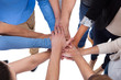 © Andrey Popov - Group of people stacking hands together