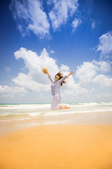 Canvas Print - Happy woman jumping at the beach