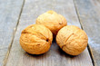 three walnuts on a wooden table