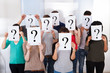 © Andrey Popov - University Students Holding Question Mark Signs