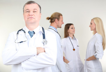 Sticker - Doctor standing in front of coworkers on grey background