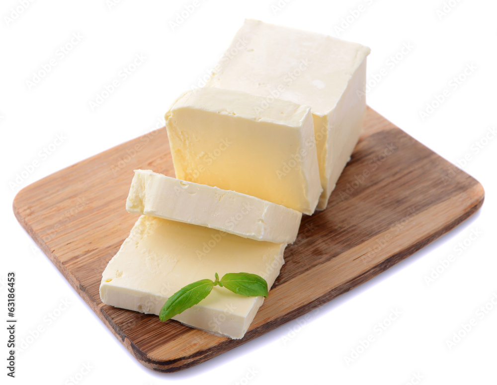 Tasty butter on wooden cutting board isolated on white