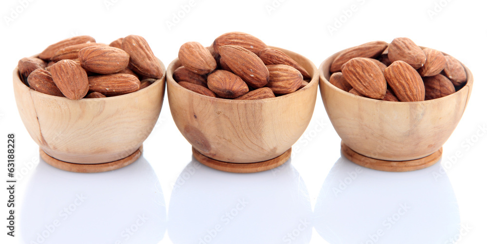 Almond in wooden bowls, isolated on white