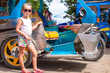 © travnikovstudio - Little girl near local transport threecycles in the Asian