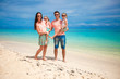 © travnikovstudio - Young beautiful family with two kids on tropical vacation