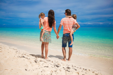 Poster - Back view family of four on beach vacation