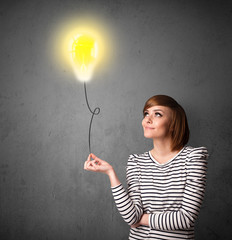 Wall Mural - Woman holding a lightbulb balloon