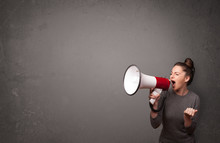 Girl Shouting Into Megaphone On Copy Space Background