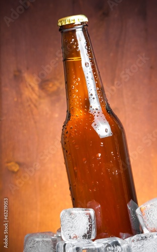 Naklejka na szybę bottle of fresh beer with drops and ice, with space for text