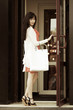 © Wrangler - Young woman with shopping bags in a mall doorway